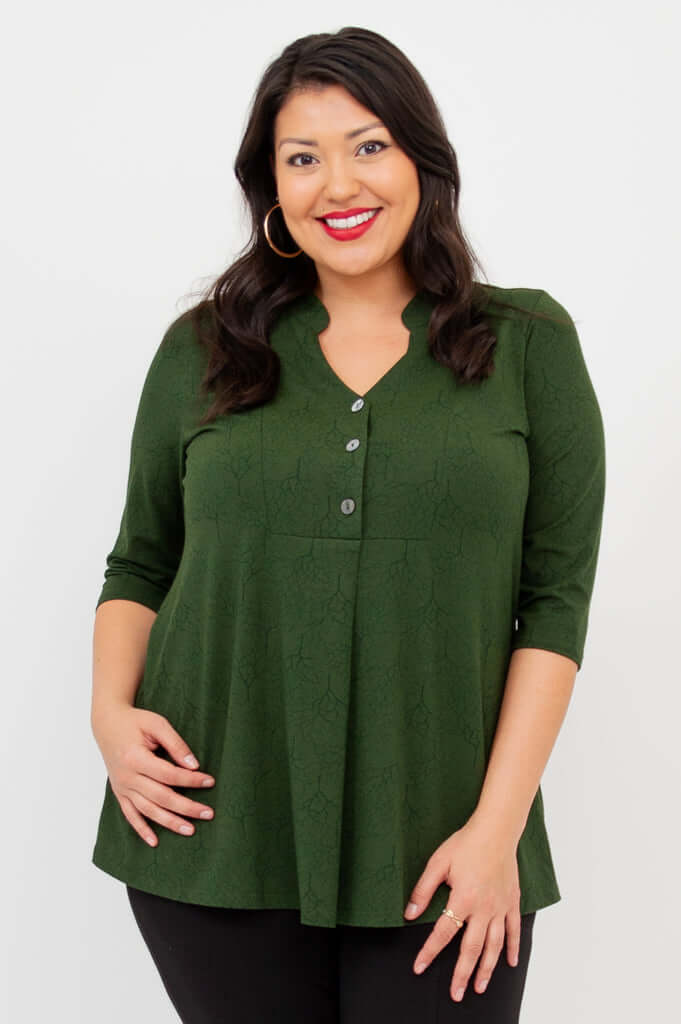 Woman wearing an Edwina dark green bamboo V-neck top with 3/4 sleeves, smiling front view