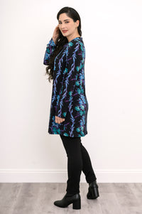 Side profile of a patterned teal and black long-sleeve tunic, highlighting its relaxed fit and straight hem.