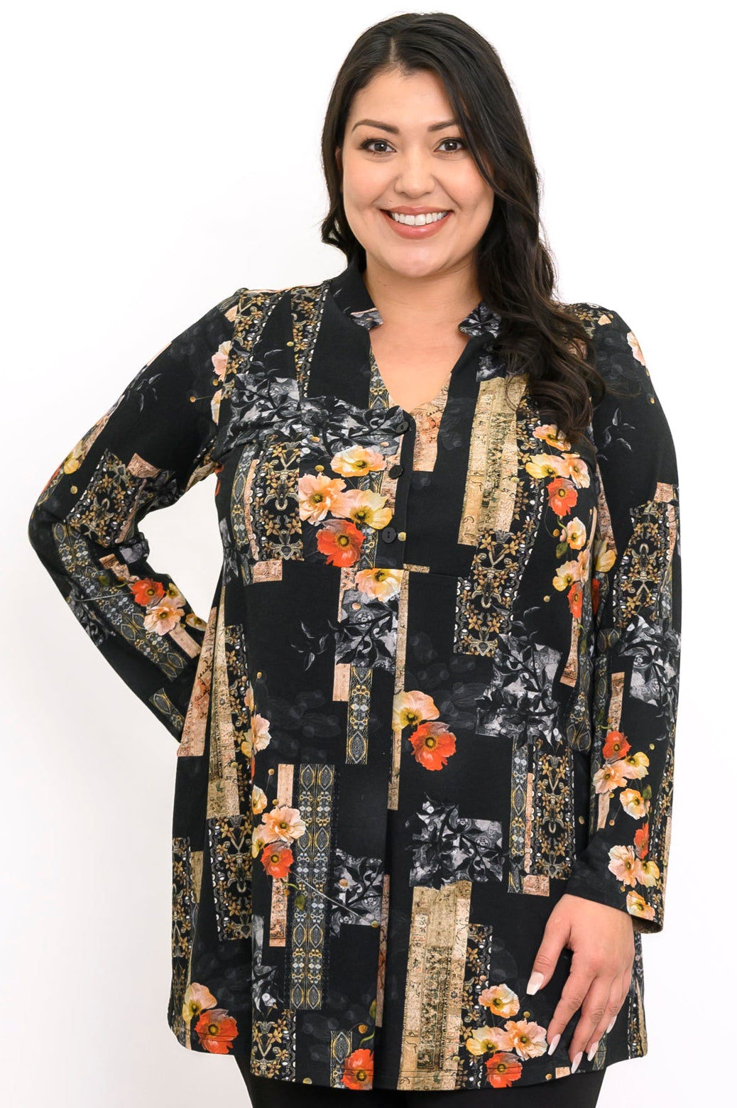 Close-up of a smiling woman in a black and orange floral bamboo tunic with a mandarin collar and V-neckline.