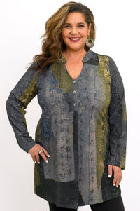 Model in a patterned olive-grey bamboo V-neck tunic featuring a three-button placket and long sleeves.