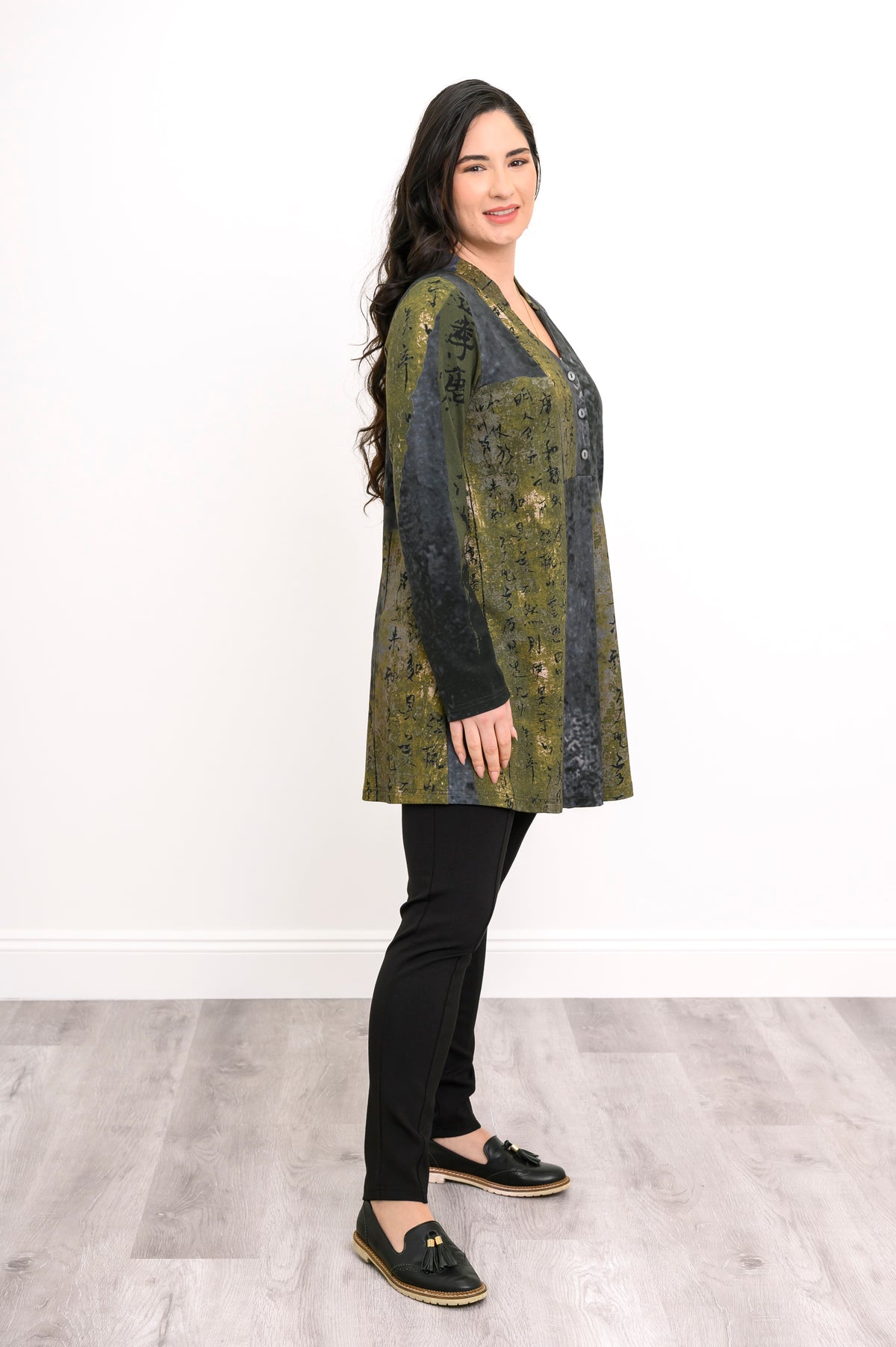 Side profile of an olive-grey patterned longline tunic, highlighting its relaxed fit and flattering hem drape.