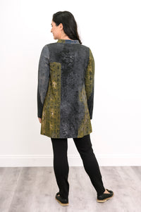 Rear view of an olive-grey print knit top, demonstrating the comfortable, hip-covering length on a model.