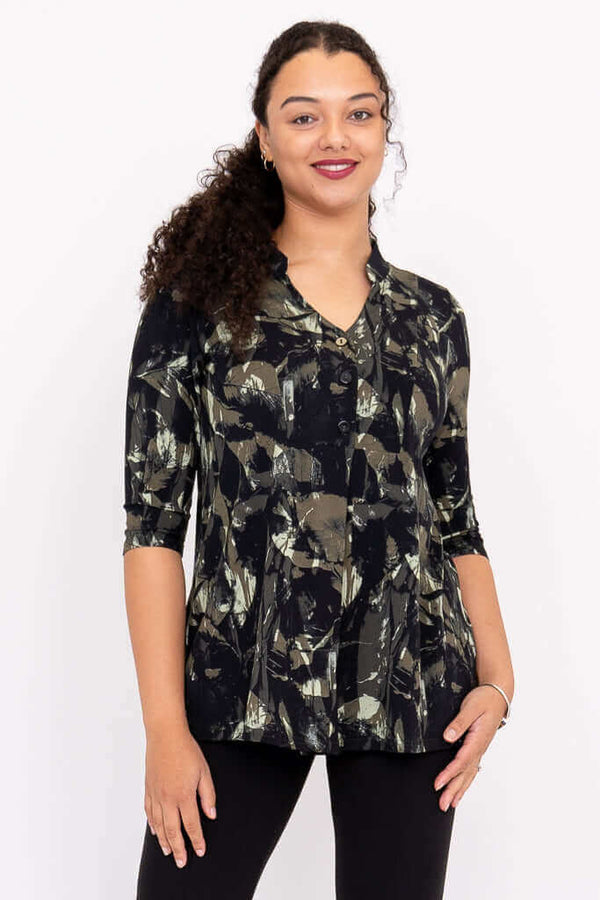 Front view of a woman wearing the Edwina top with abstract black and olive print and 3/4 sleeves