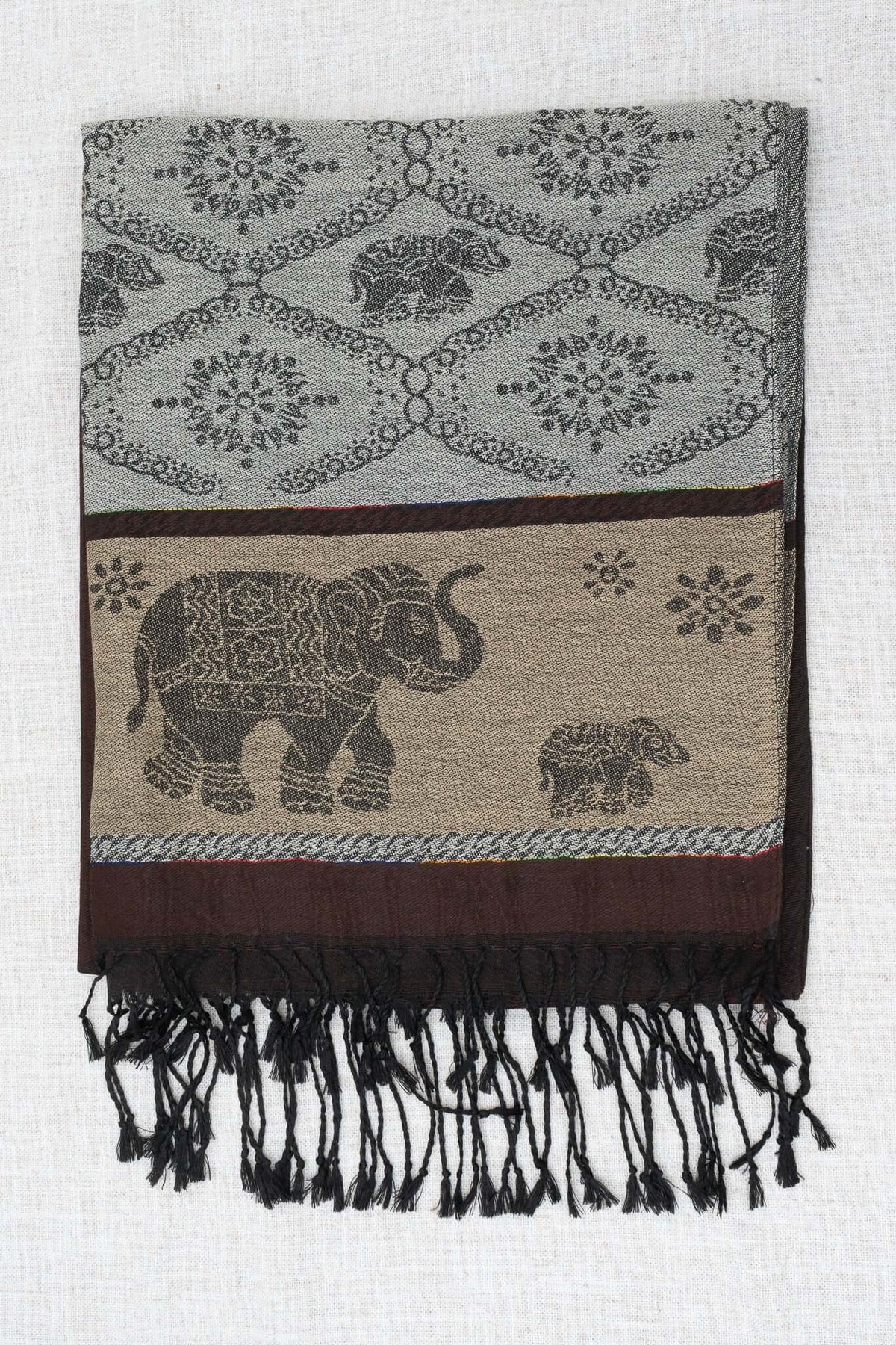 Folded pashmina scarf with intricate elephant and floral designs in grey, brown, and beige tones