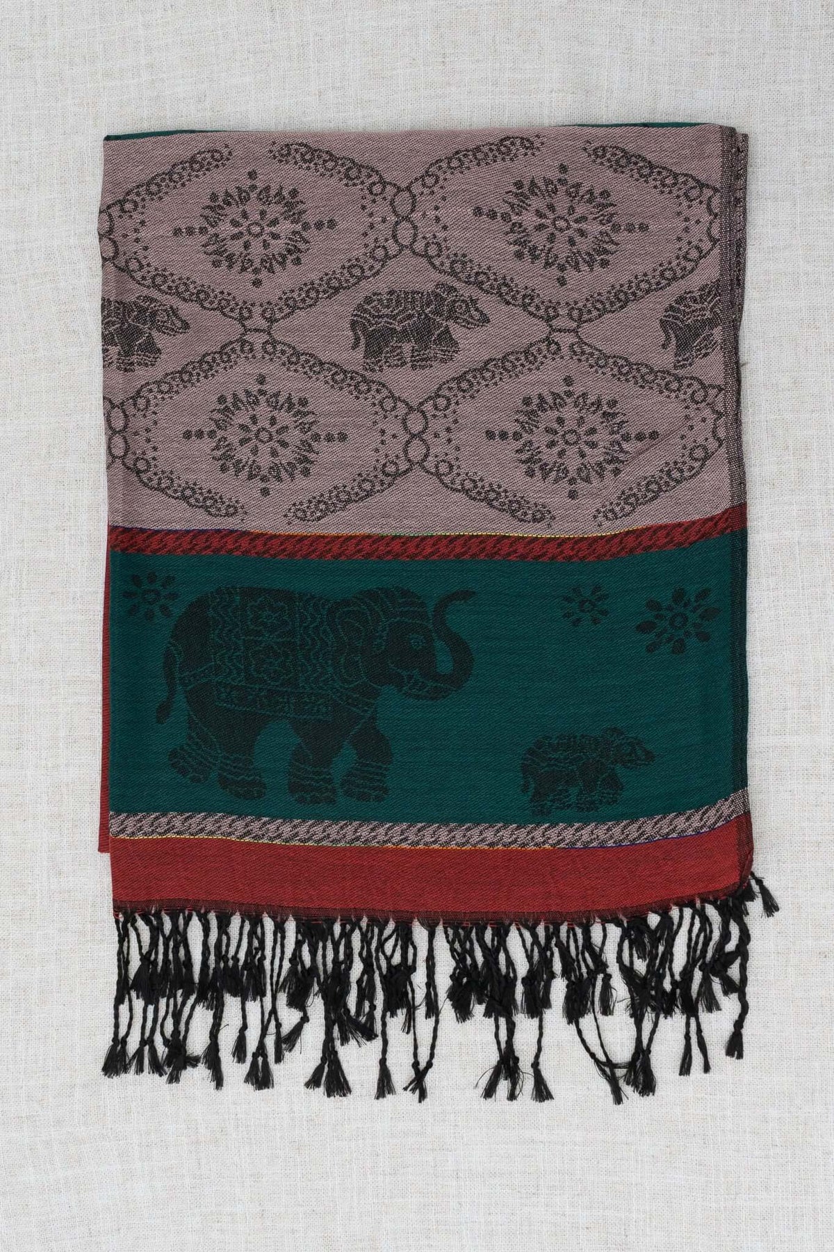 Unfolded pashmina scarf displaying elephant and floral motifs with black fringe