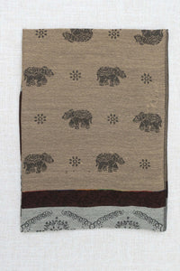 Folded pashmina scarf featuring intricate elephant and floral motifs on a beige background