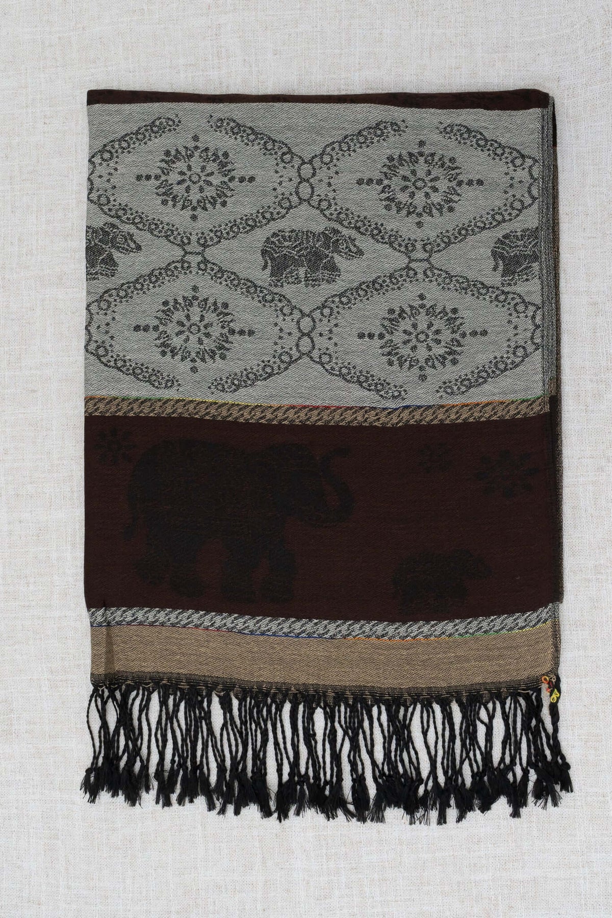 Pashmina scarf with elephant and floral designs, brown accents, and black tasseled edges