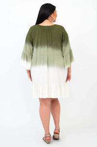 Back view of a woman in an olive green and white ombre dress with ruffle hem and 3/4 sleeves