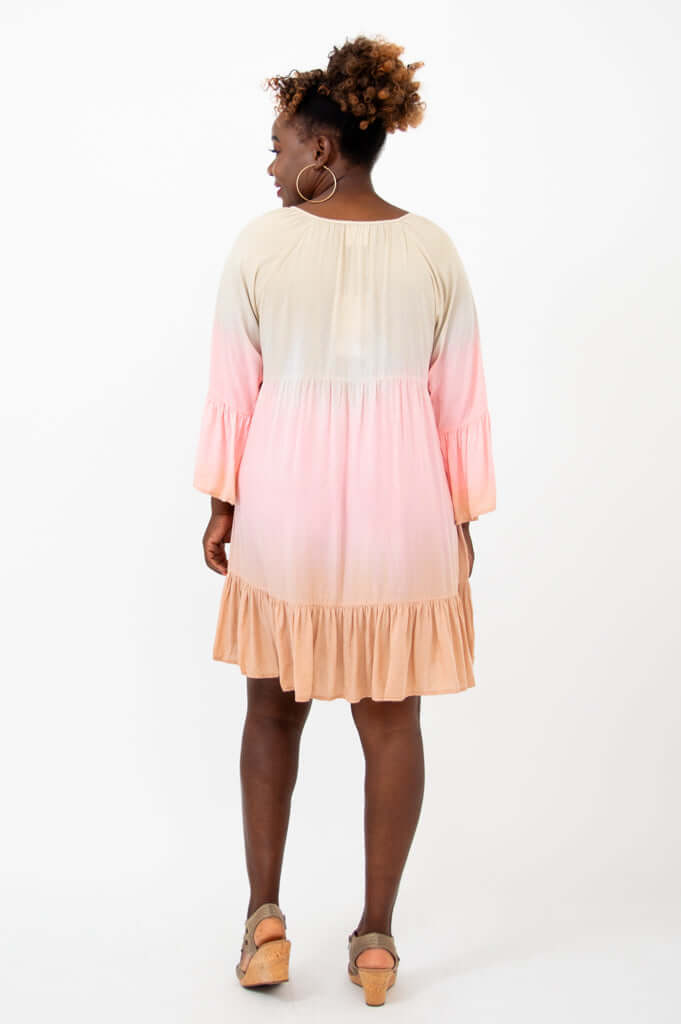 Back view of Ellie Dress showing gradient colors, ruffle hem, and sleeve detail