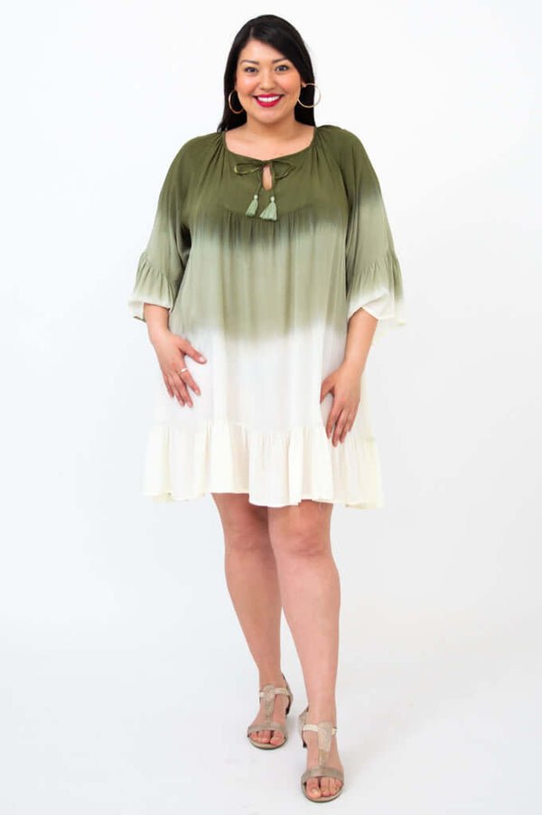Front view of a woman in a flowy green and white ombre boho dress with ruffled hem