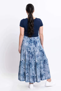 Back view of a woman in a navy and blue floral print empire waist maxi dress