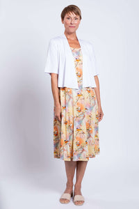 Full length shot of woman in pastel tank dress and white cardigan