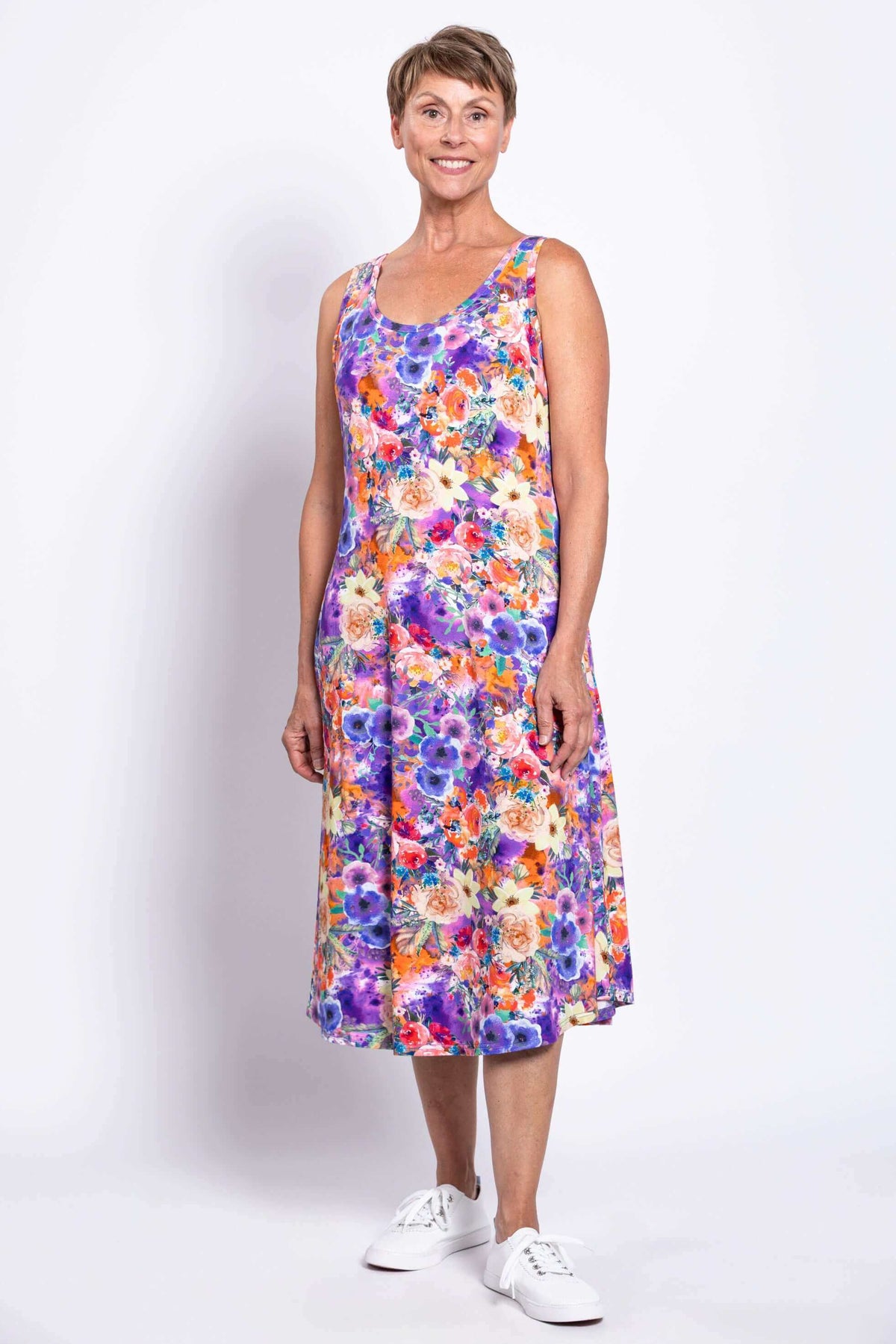 Woman smiling in a floral bamboo tank dress, front angle