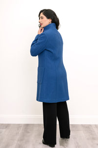 Back view of woman modelling long coat with pockets in cobalt blue boiled wool fabric