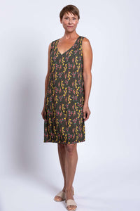 Woman wearing sleeveless green floral V-neck dress, front relaxed pose
