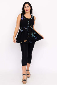 Woman displaying flared shape of black batik tank top with dragonfly print and button detail