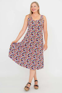 Woman displaying the flared skirt of a floral Evangelina tank dress