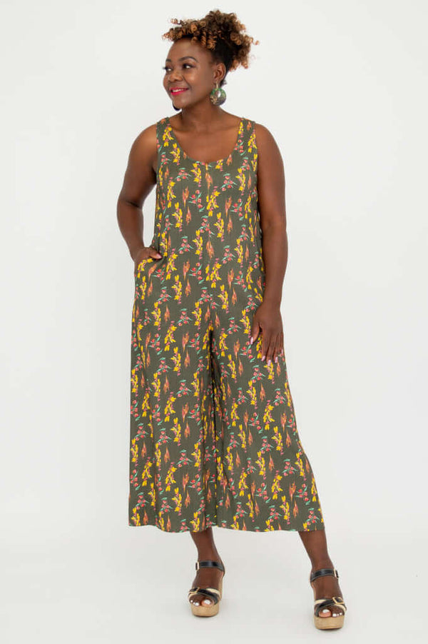 Model smiling in cropped floral jumpsuit with side pockets