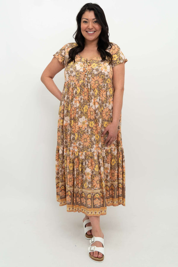 Woman wearing a floral Sharpie dress with flutter sleeves and front buttons