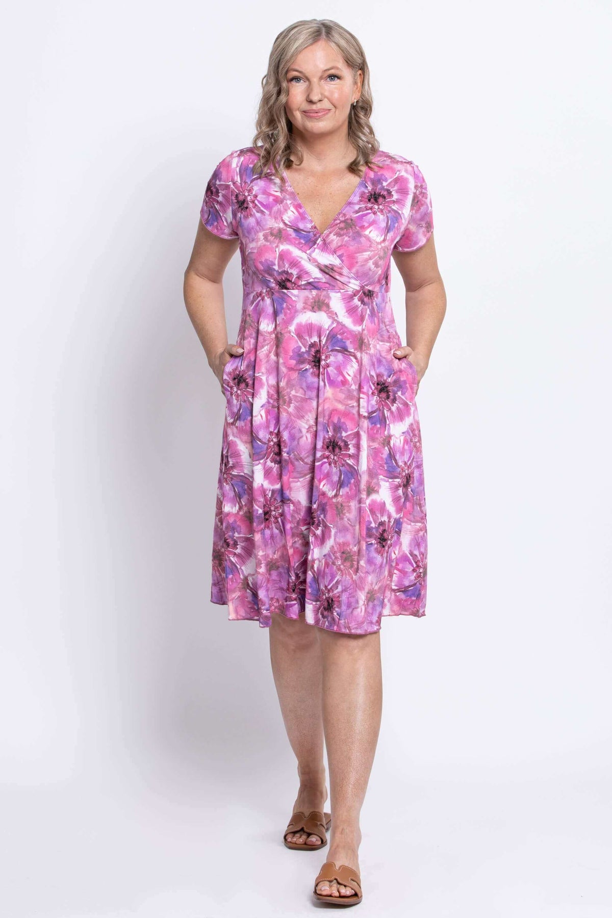 Woman posing with hands in pockets, wearing pink purple floral bamboo dress