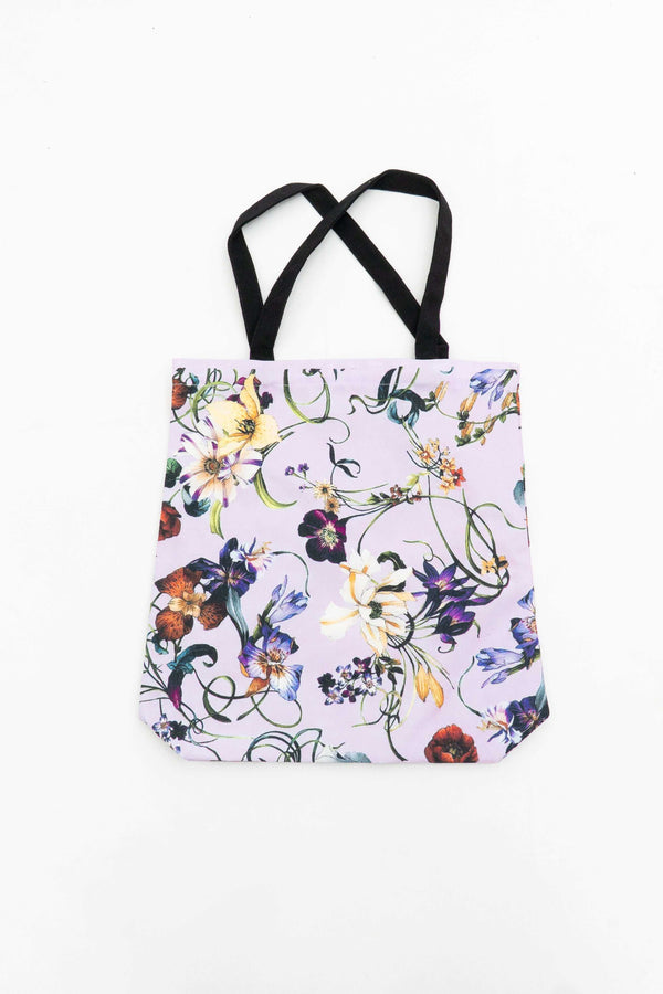 Eco-friendly canvas tote bag with colorful floral print and black handles