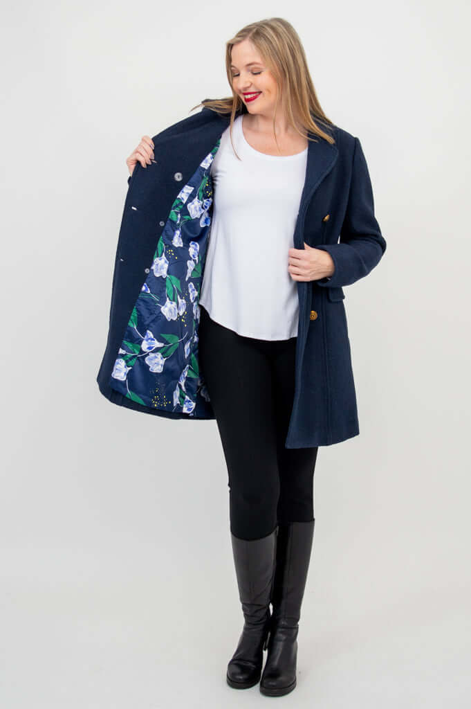 Woman displaying floral print lining inside navy wool pea coat