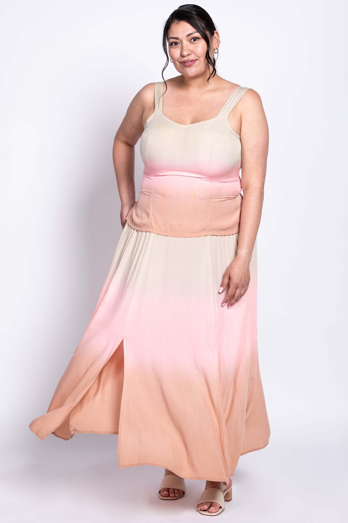 Sleeveless ombre maxi dress with flowing skirt captured in a dynamic pose