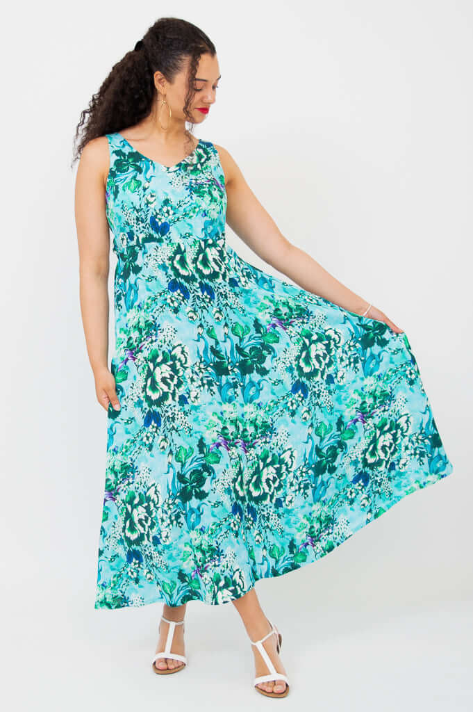Model showcasing the flowy skirt of the Coraline aqua maxi dress