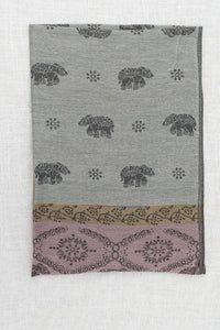 Folded pashmina scarf with elephant and floral patterns in grey, mauve, and taupe tones