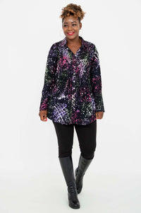 Front view, walking pose of a woman in the Cindy smocked shirt with a colorful pattern