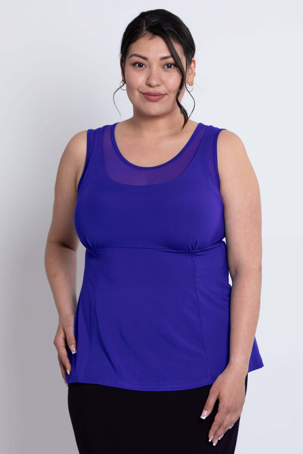 Front close-up of plus size model wearing a vibrant purple mesh detail tank top