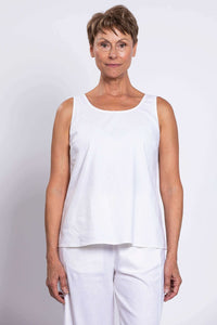 Front close-up view of woman wearing a sleeveless white linen tank top
