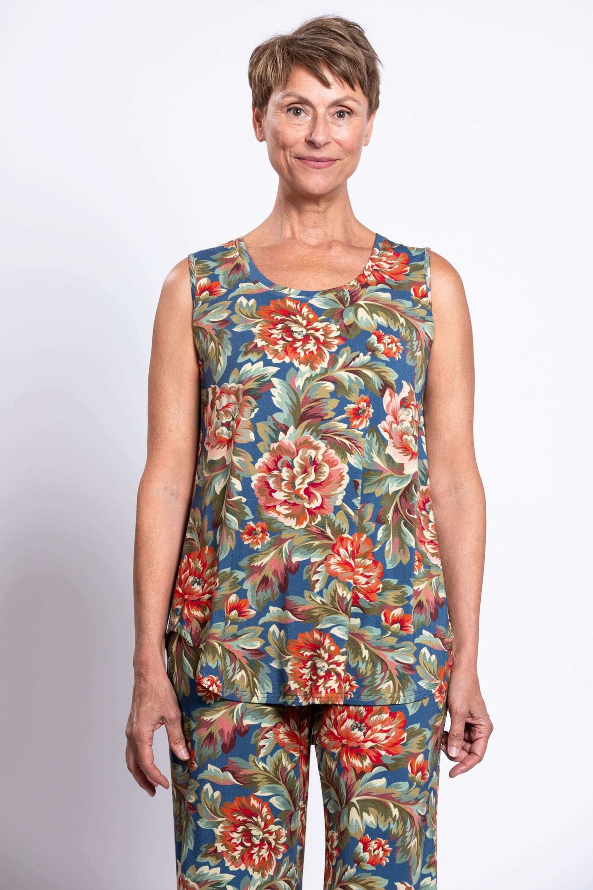 Woman wearing sleeveless floral peony print tank top and matching wide-leg pants, front close view