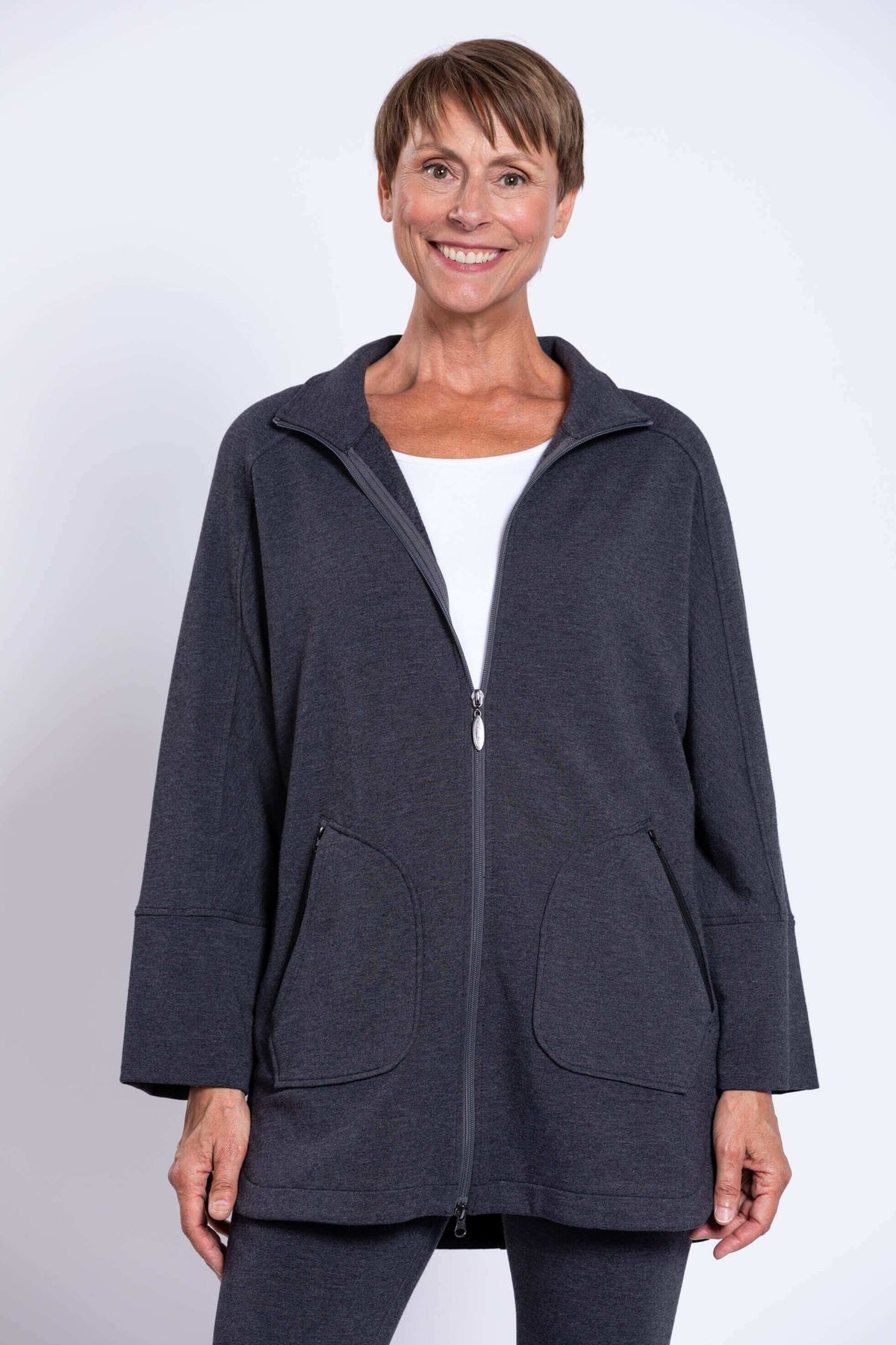 Front closeup of woman wearing charcoal zip-up Taran Jacket with dolman sleeves