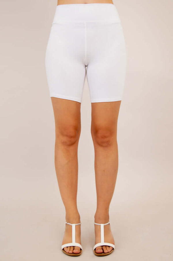 Front view of woman modeling white bamboo shorts with high waist