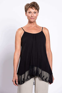 Front view of a woman wearing a black lace-trimmed tank top with spaghetti straps