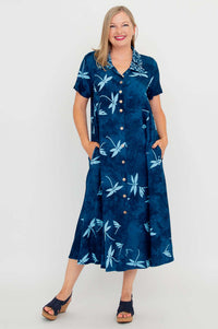 Front view of woman wearing a blue button-up dress with light blue dragonfly patterns