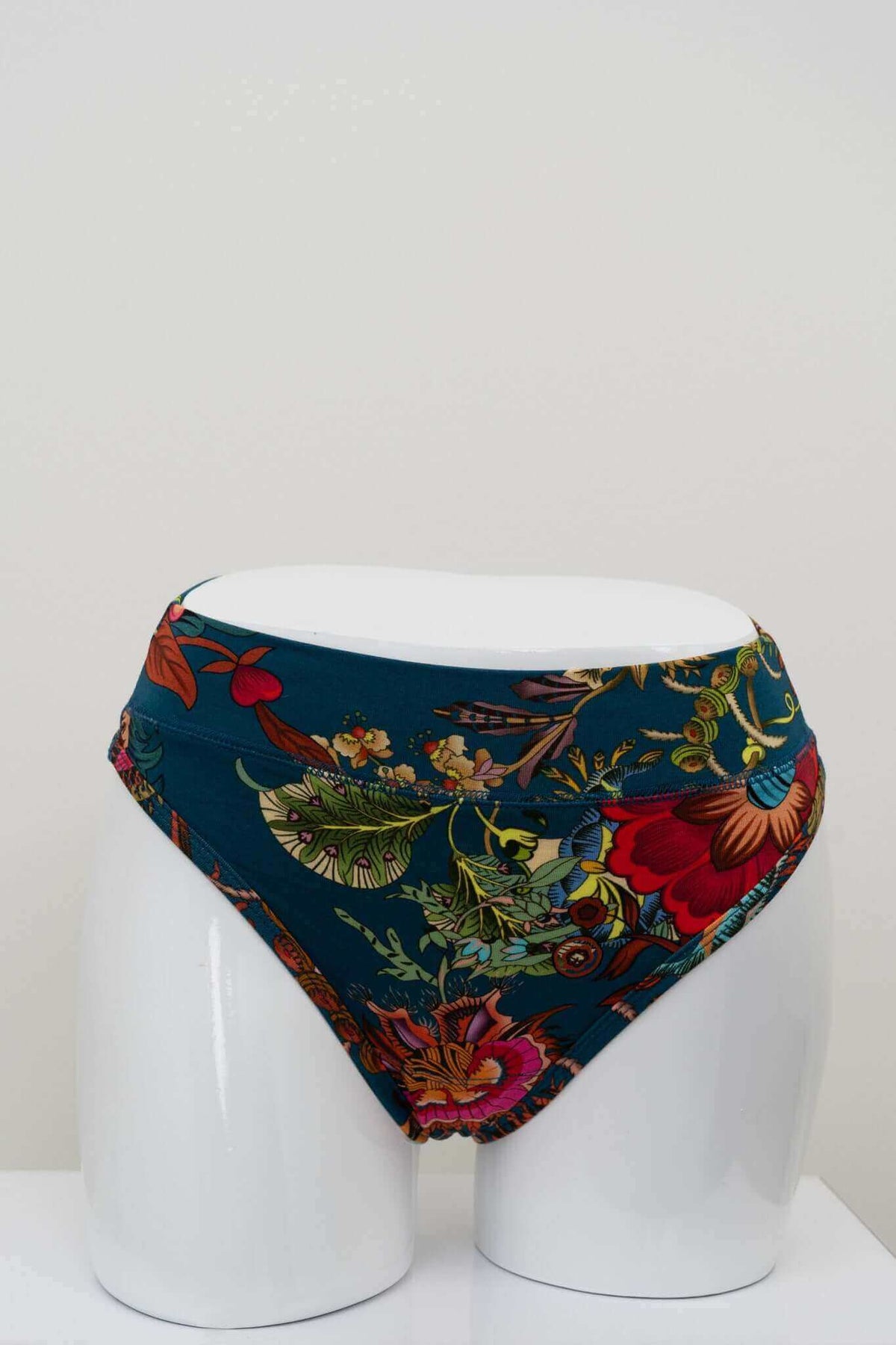 Front view of high rise bamboo thong with vibrant floral pattern on white mannequin