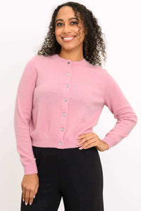 Front view of a woman wearing a pink cashmere cardigan with buttons