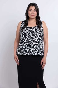 Model front pose in sleeveless Ikat print tank top, black skirt visible