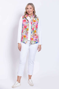 Front view of woman in a pink floral print vest, standing with arms relaxed