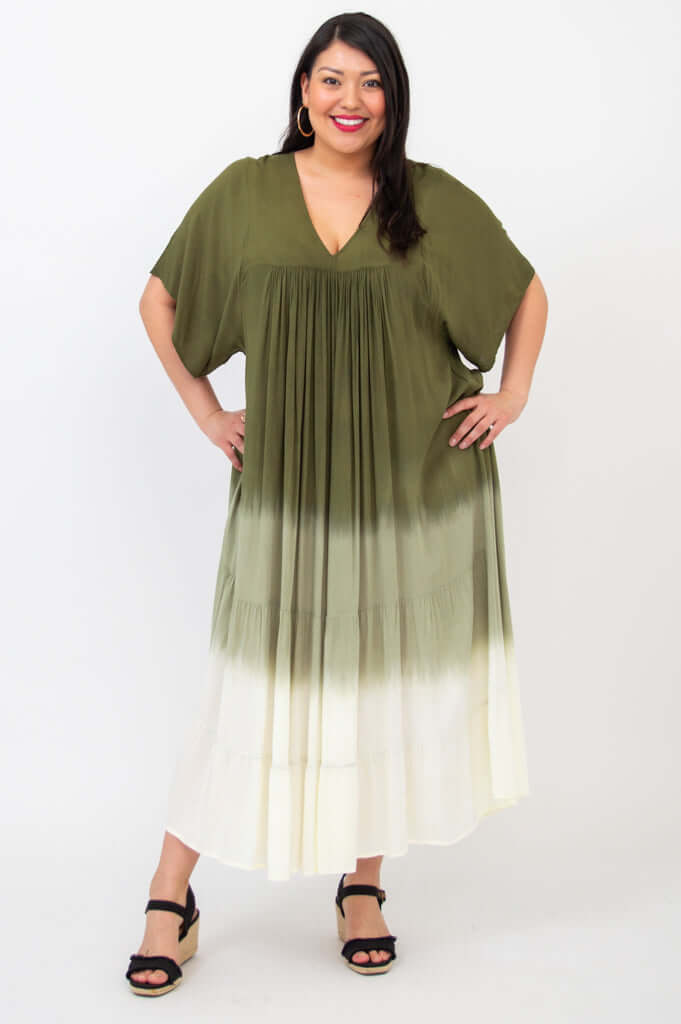 Front pose of a woman in a green and white gradient flowy maxi dress