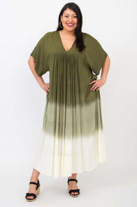 Front pose of a woman in a green and white gradient flowy maxi dress