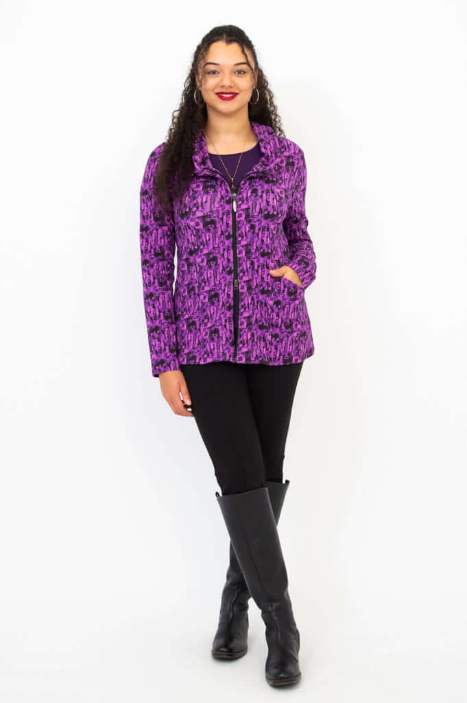 Model standing, front view, wearing hooded Seymour bamboo hoodie in purple