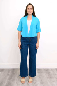 Front view of model standing in blue cropped bamboo jacket and jeans