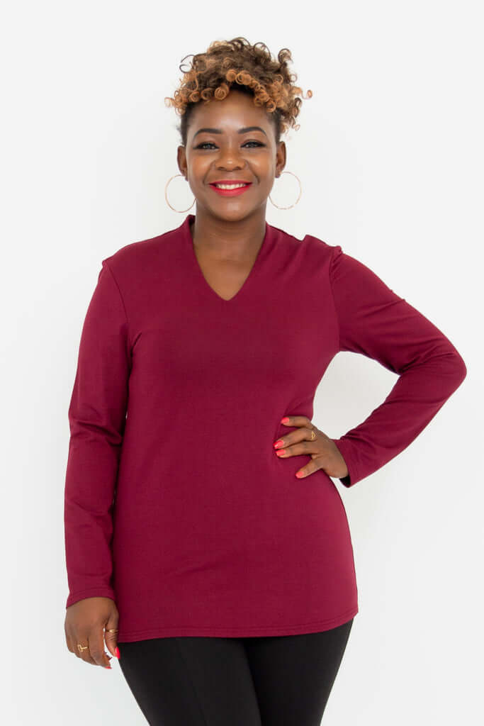 Front view of woman wearing a long sleeve burgundy V-neck bamboo top