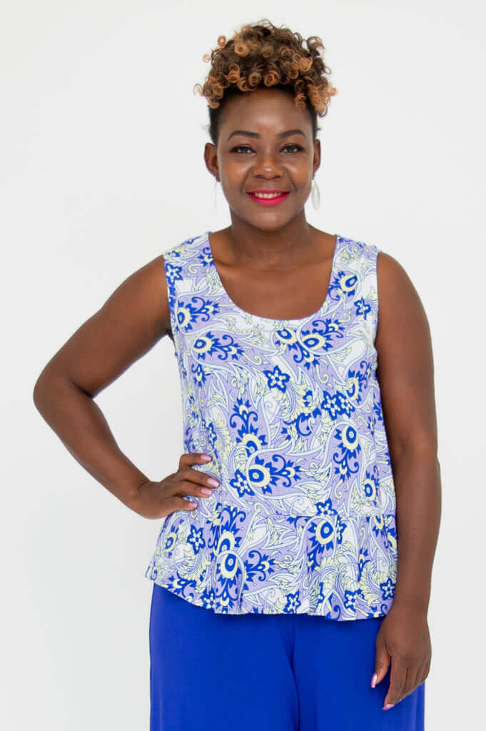 Front view of model wearing blue and white floral Ginny Tank with peplum hem