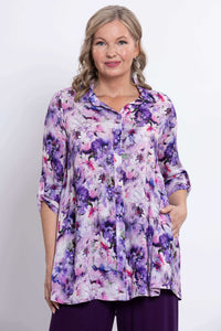 Front view of model wearing a purple floral bamboo-linen tunic shirt