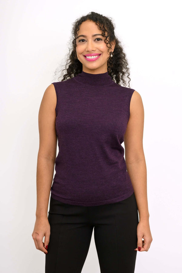 Front view of a woman wearing a sleeveless purple mock neck merino wool sweater