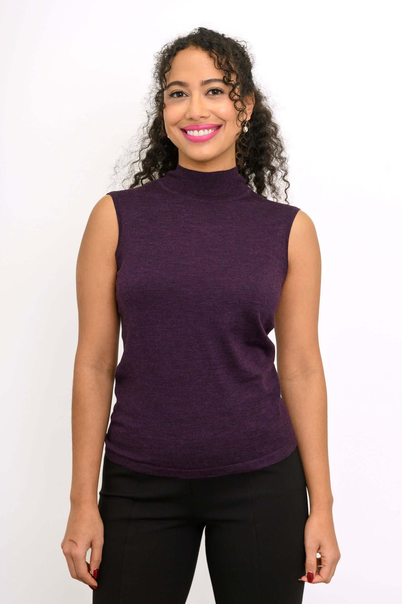Front view of a woman wearing a sleeveless purple mock neck merino wool sweater
